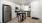 Spacious and well lit kitchen with wood flooring and stainless steel appliances