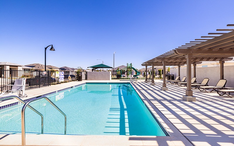 Spacious sparkling pool with sundecks and cabanas for lounging.